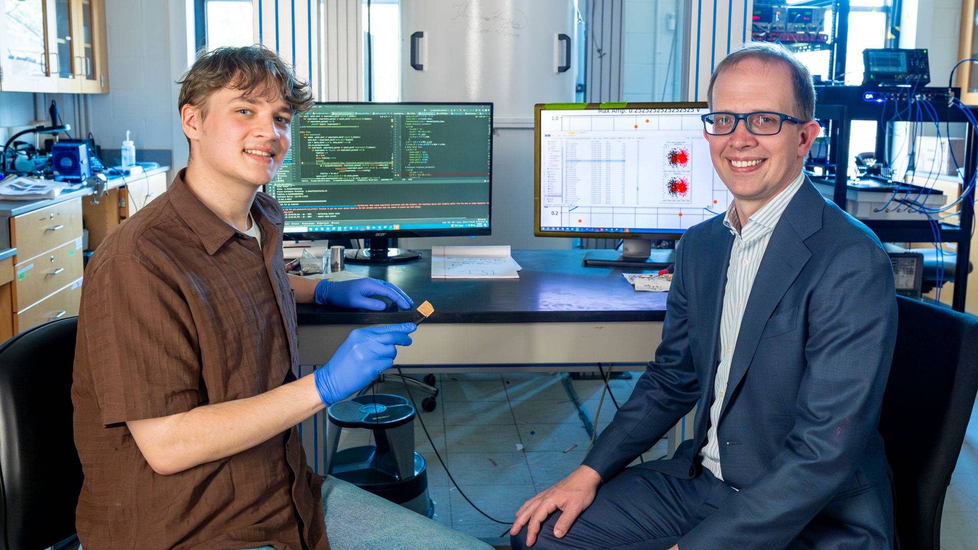 Princeton senior Thomas Verrill with thesis adviser Andrew Houck at their computer monitors.
