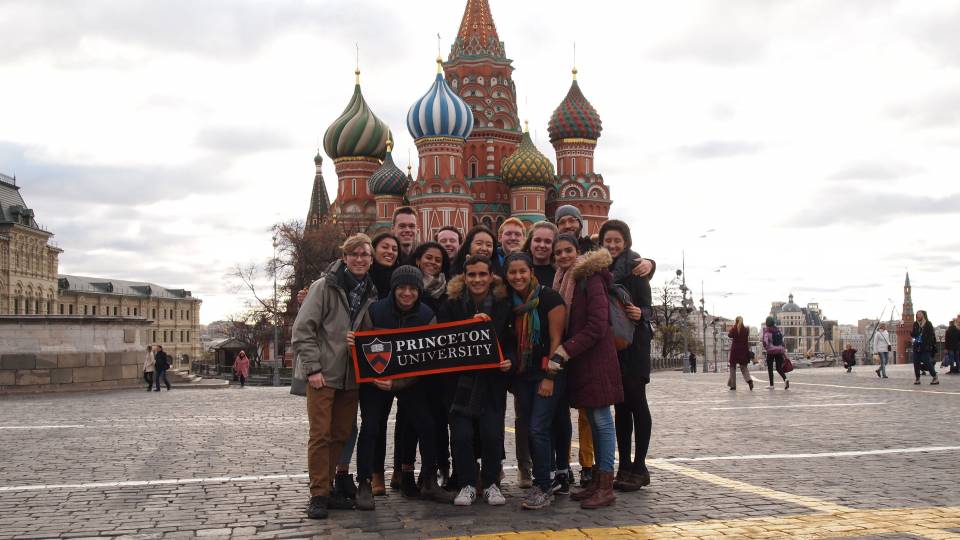 Students holding Princeton banner in front of buildings