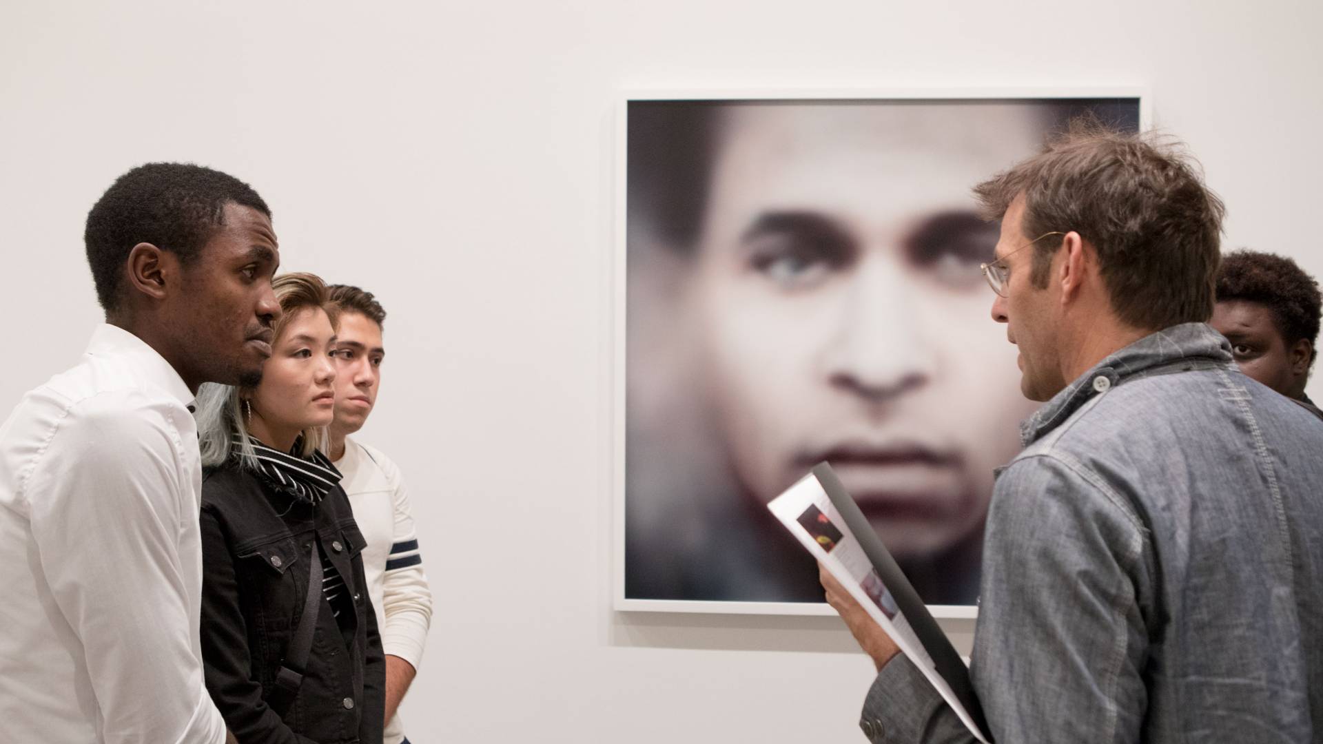 Professor Whetstone discusses photo with students at New York gallery