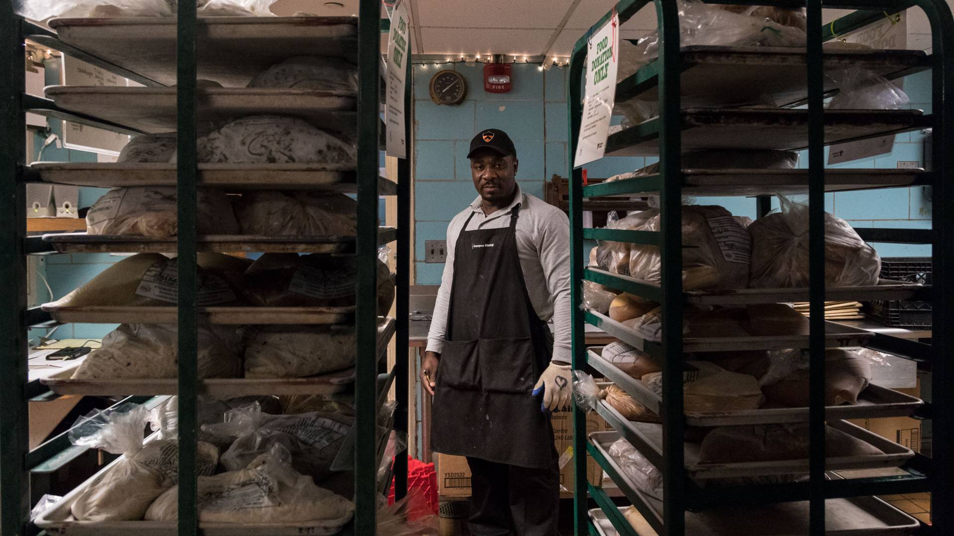 X standing in between racks of food
