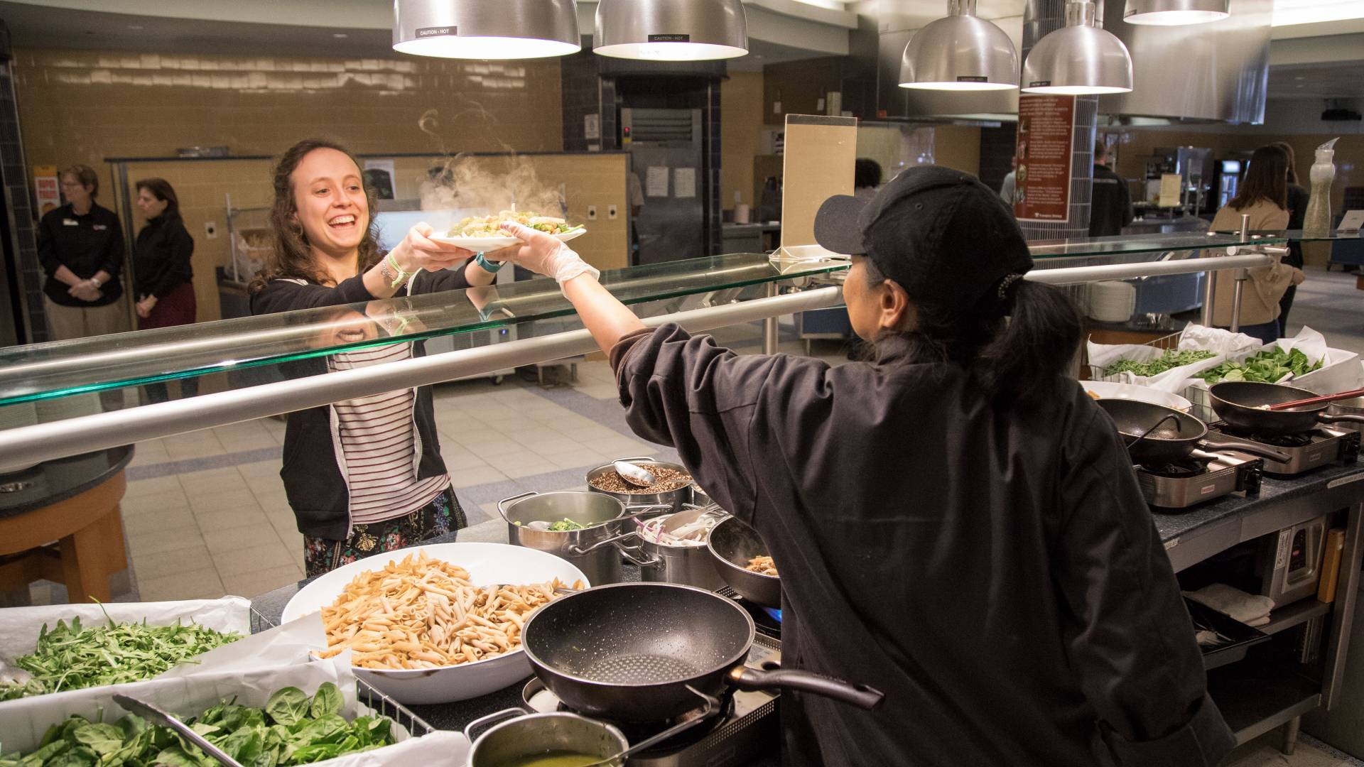 Student being served plate of hot food