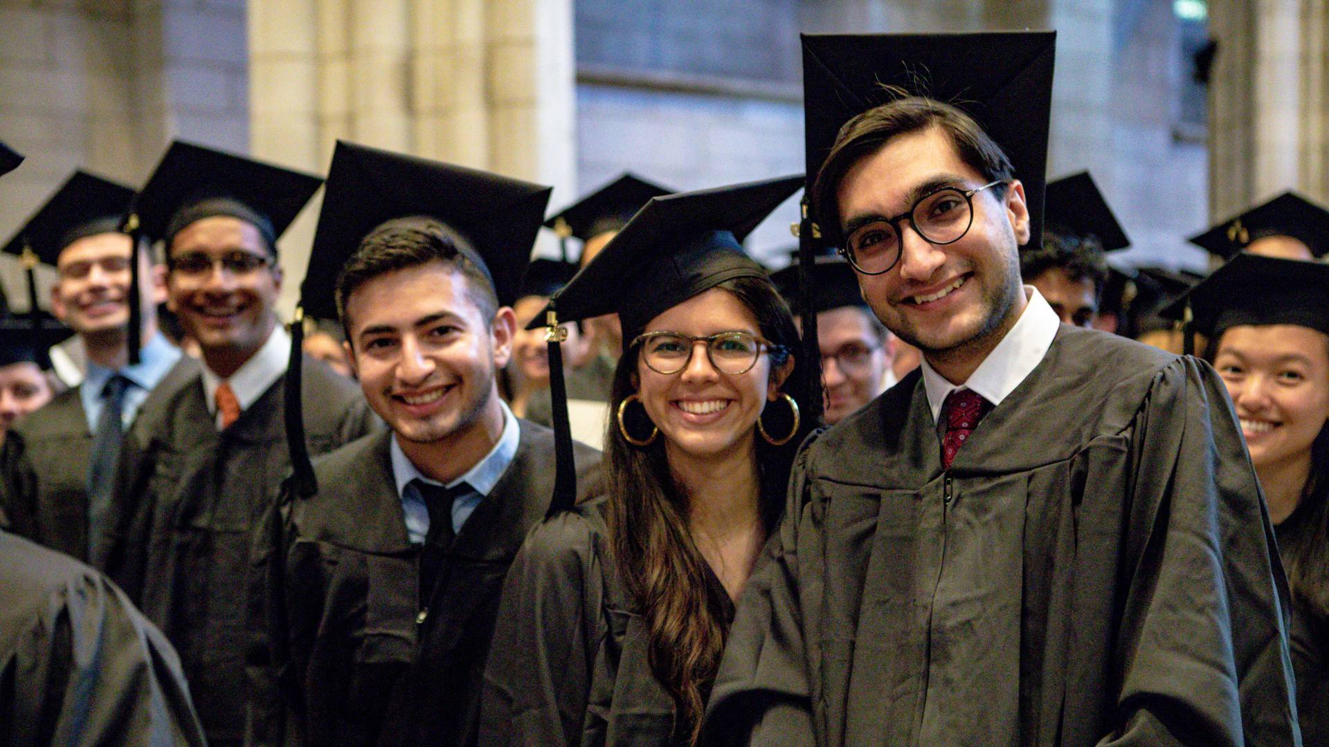 Students standing and smiling during Baccalaureate
