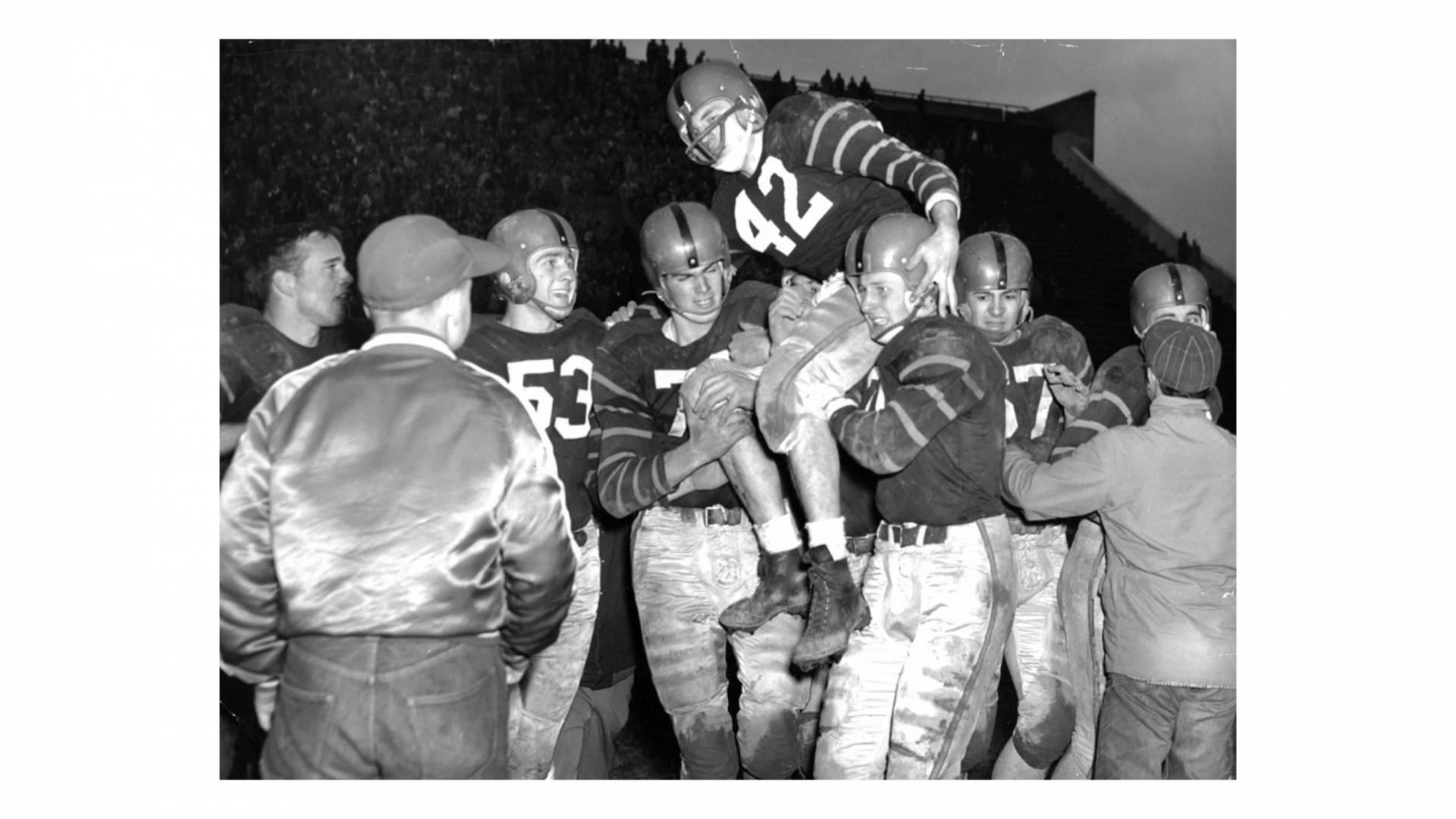 football players lift one of their own on their shoulders