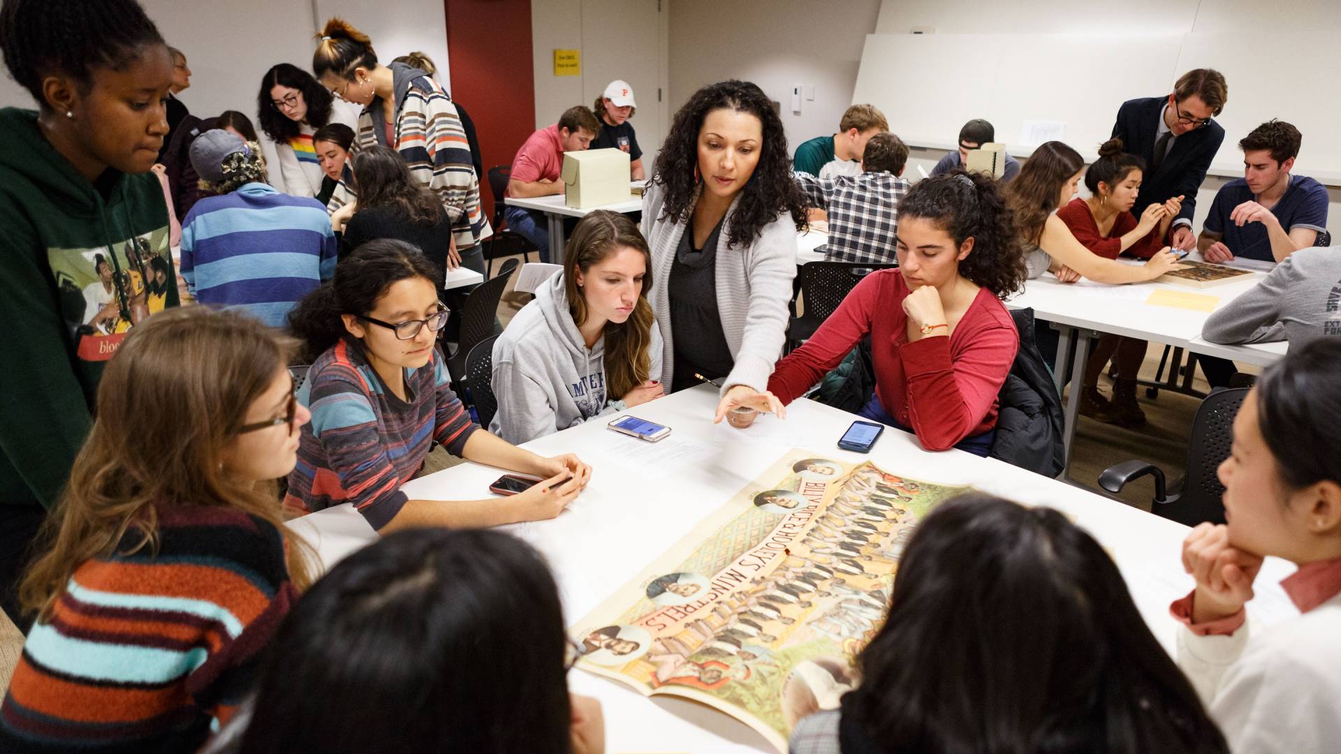 Professor and students look at materials from special collections