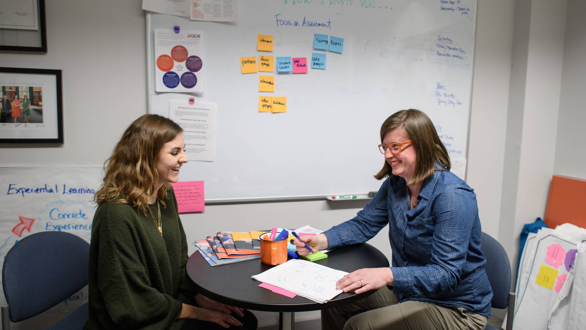 Eyestone and McNamara having a converation while sitting across a table from each other
