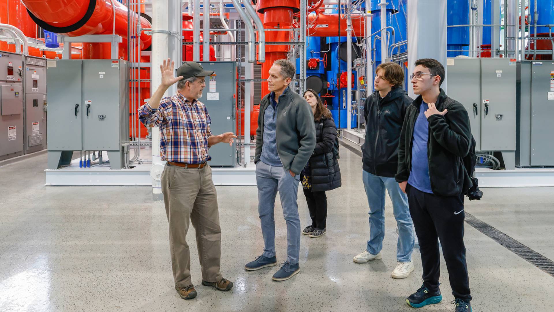 Ted Borer (left), director of the energy plant, leads a tour of the TIGER facility, which was recently featured in a New York Times story about the University's geo-exchange energy system.