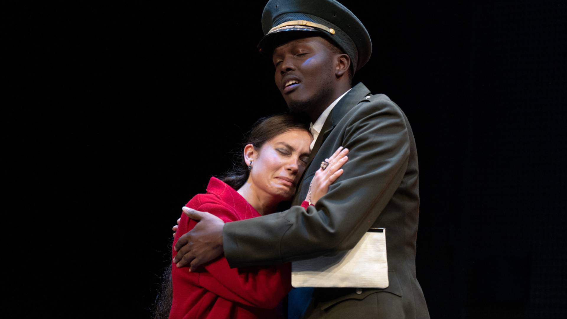 Two actors embracing.