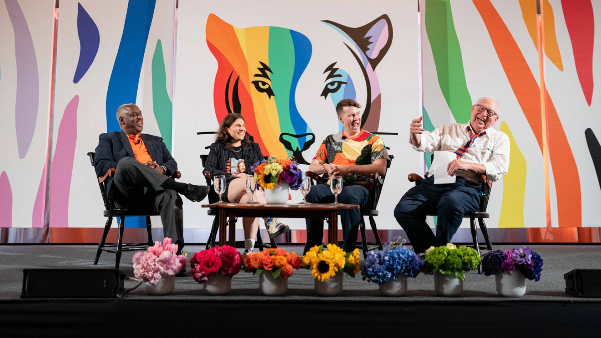 A group of people on stage laughing.