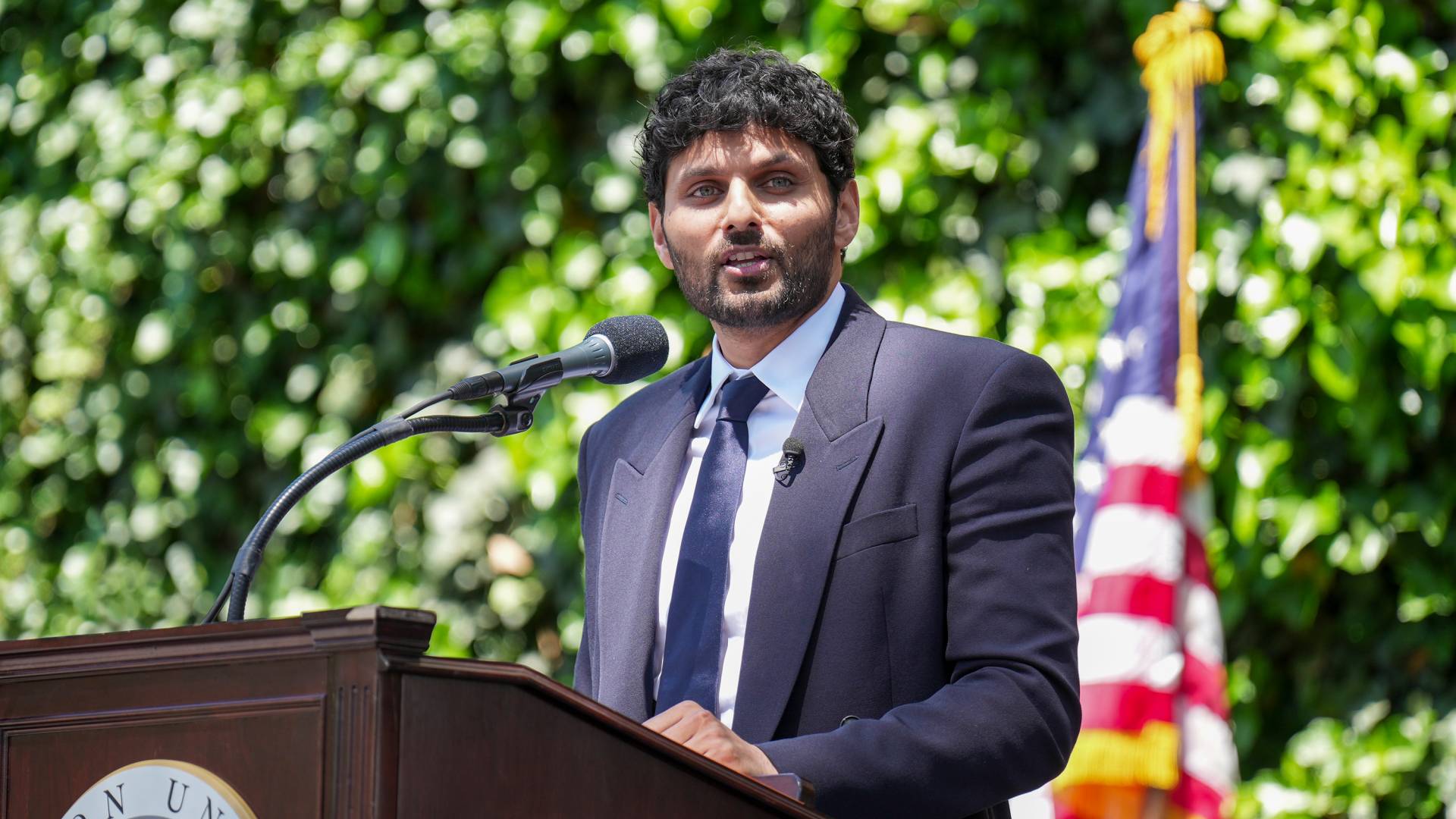 Jay Shetty speaks from a podium onstage.