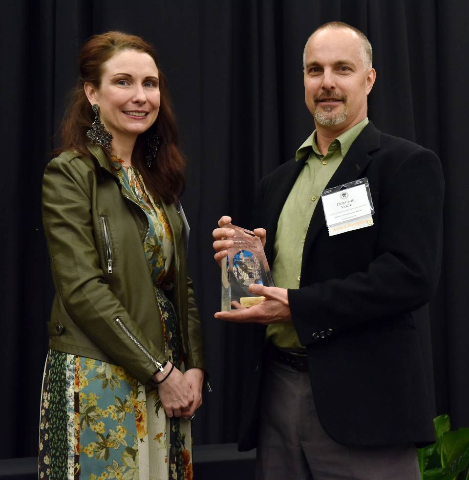Nic Voge receiving award from Maureen Connolly