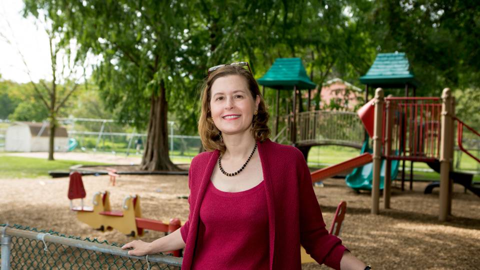 Janet Currie standing in front of playground