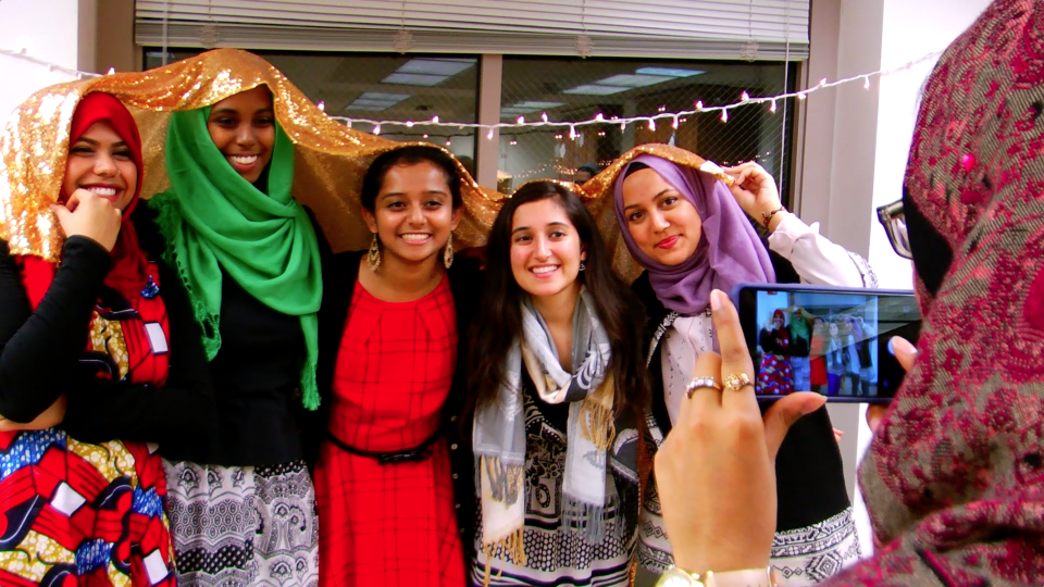 Students posing for photographer at Muslim Life event