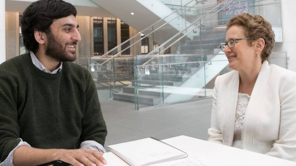 Nabil Shaikh '17 with senior thesis advisor, Professor Melissa Lane, in the cafe of the Simpson International Building