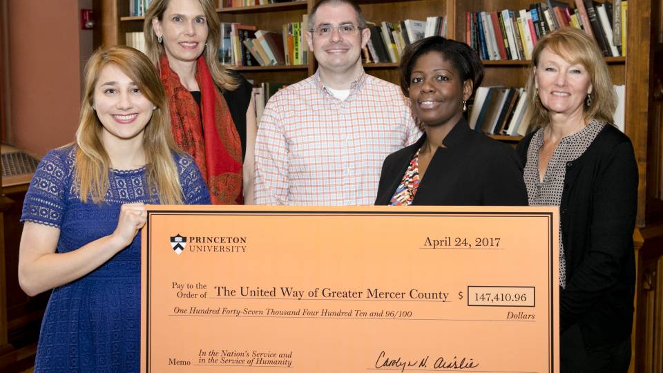 United Way and Princeton University staff holding donation check