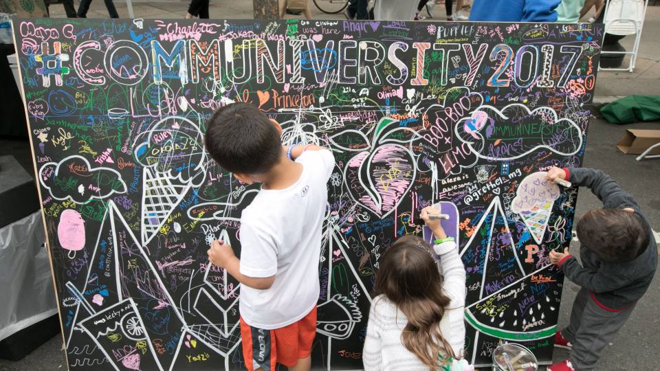 The annual Communiversity Artsfest includes arts and crafts demonstrations and activities ranging from tissue paper flowers to oil painting. Above, children add their own artistic flourishes to a Communiversity sign.