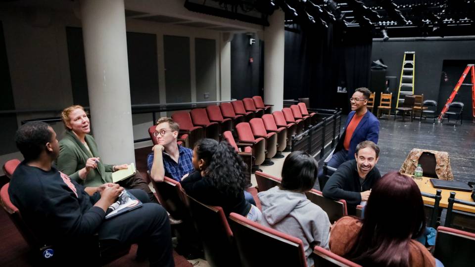 Students discussing song writing in Atelier course