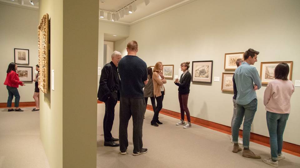 Students and professor looking at Landscapes Behind Cezanne exhibit