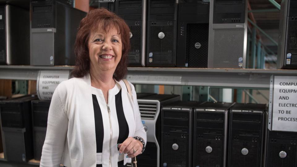 Danise Daniels in front of recovered computers