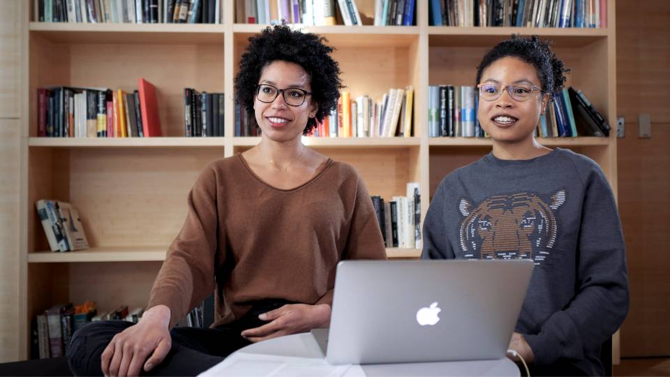 Claudia and Laura Roberts sitting in front of laptop