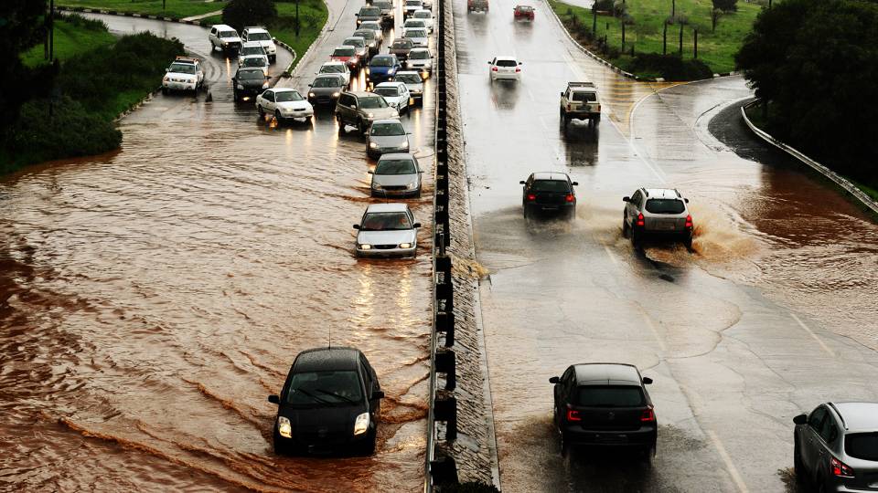 Cars driving through a flooded highway