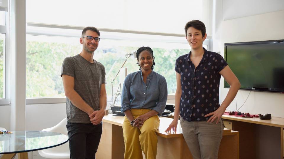 3 researchers in front of a desk