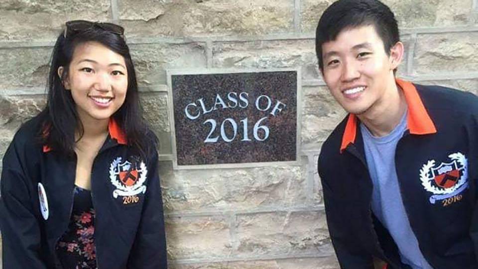 2 students pose in front of a Class of 2016 plaque