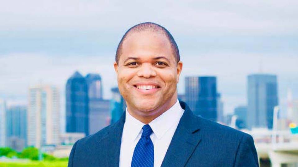 Eric Johnson with a skyscape in the background