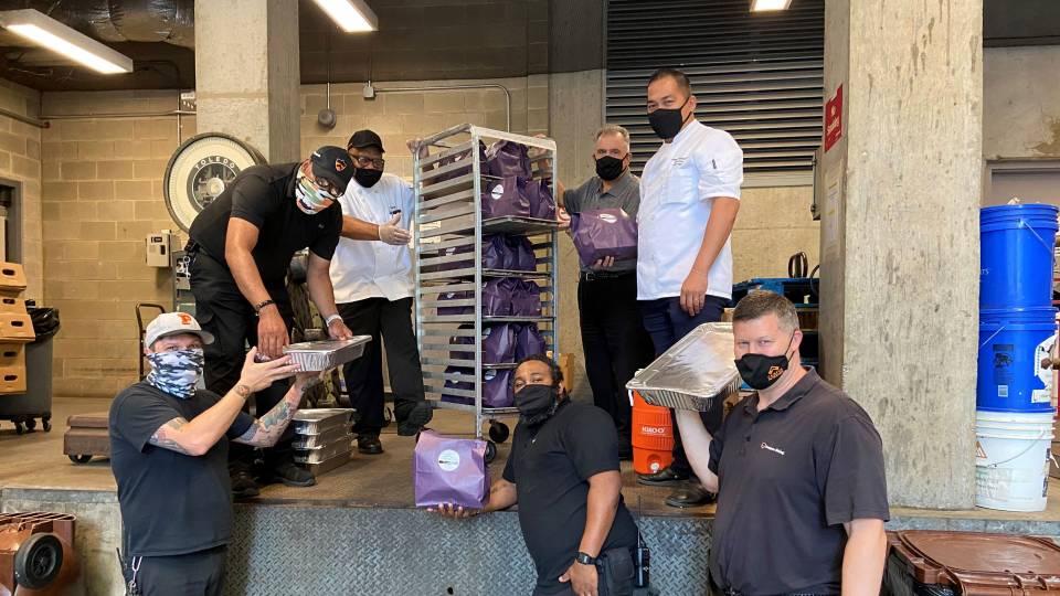 Princeton employees loading food packages for delivery