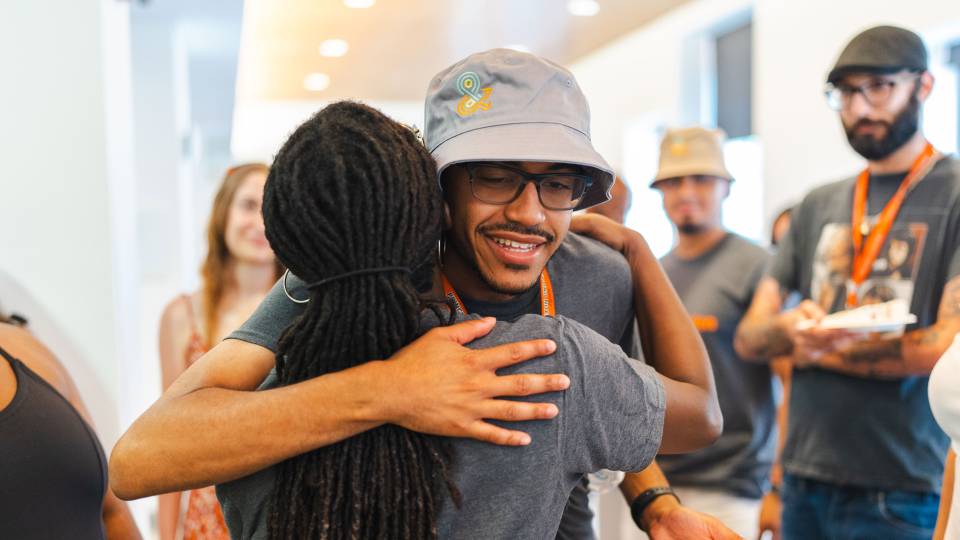 A student and an organizer of the Emma Bloomberg summer programs say their goodbyes at a closing event.