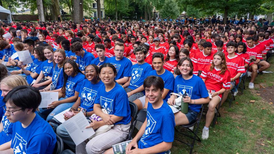 Frosh wearing their residential college t-shirts, await opening exercises remarks to begin