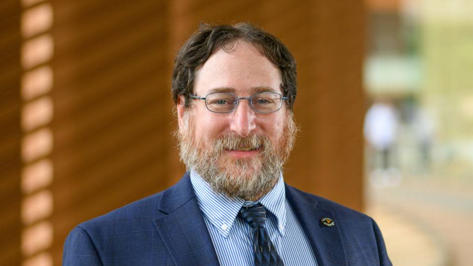 Craig Arnold wearing a suit and tie