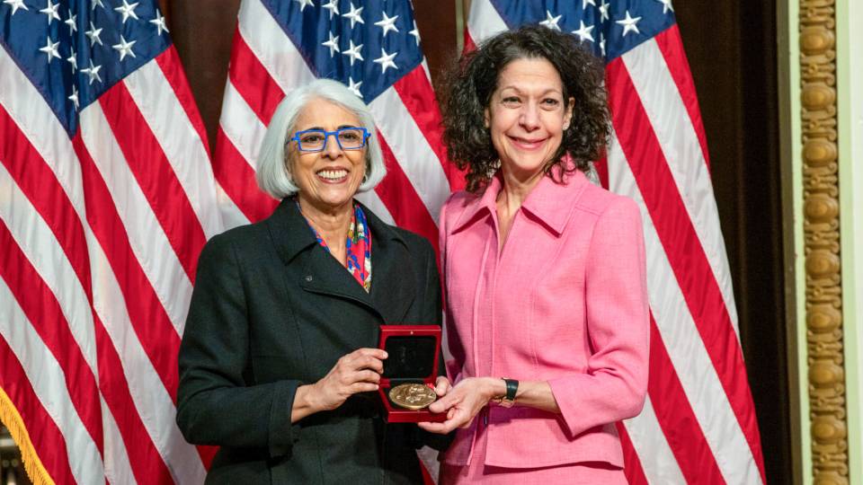 Bonnie Bassler smiles with a White House official.