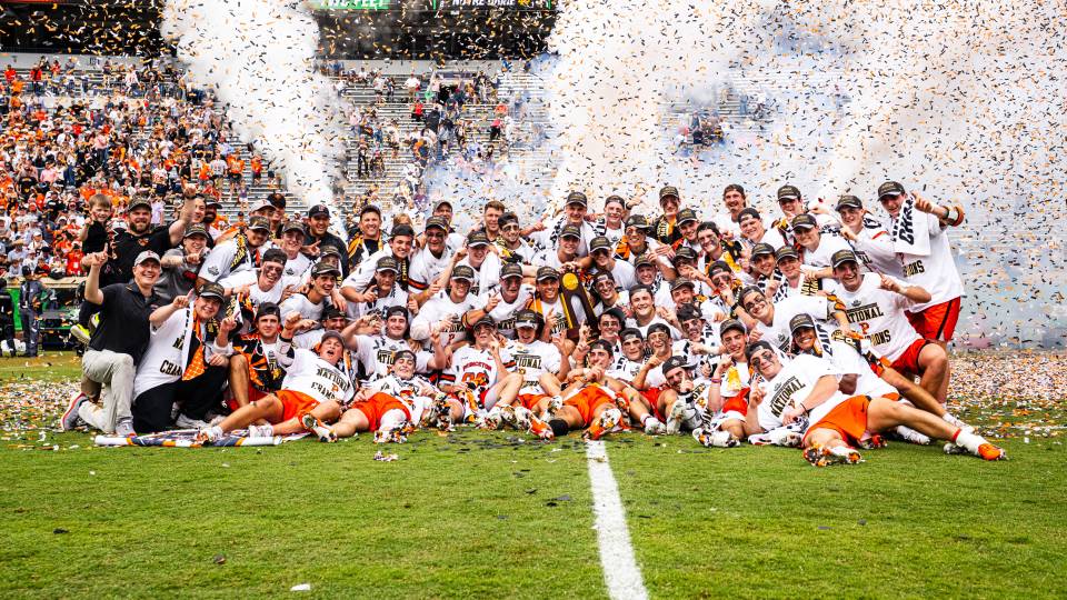 The men's lacrosse team celebrates after the championship game
