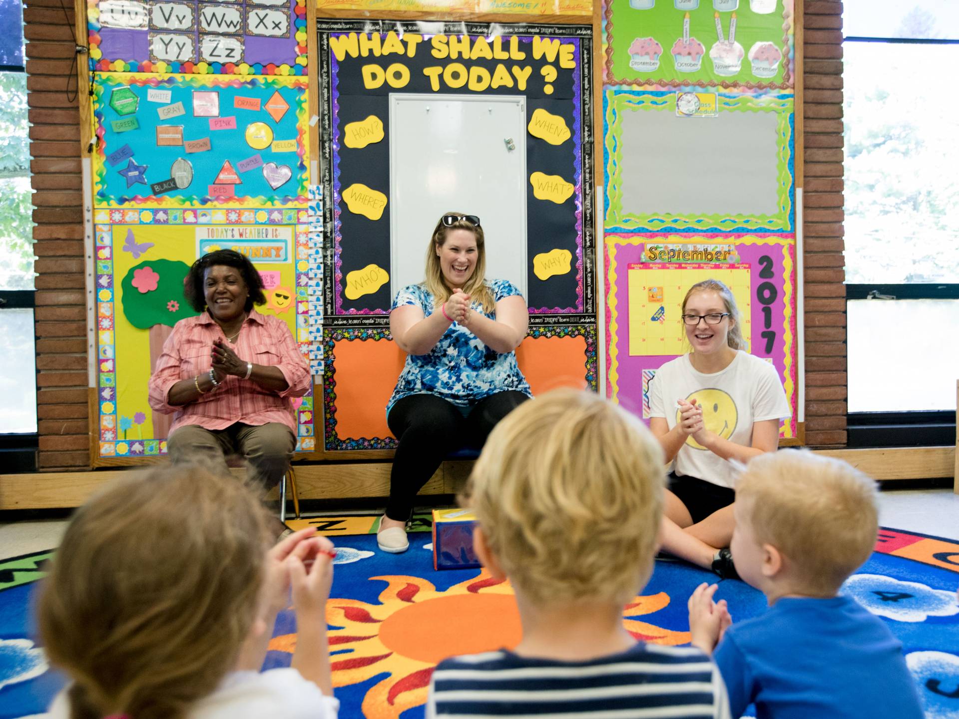 Student and teachers singing to preschoolers