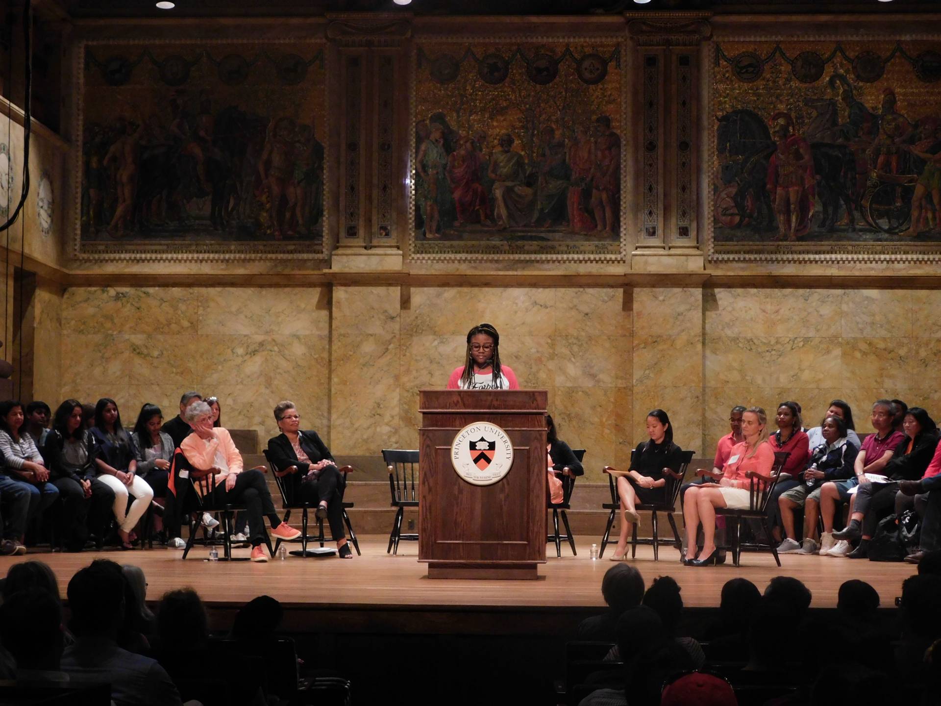 Myesha Jemison speaks to an audience family members during the Orientation welcoming program at Richardson Auditorium.