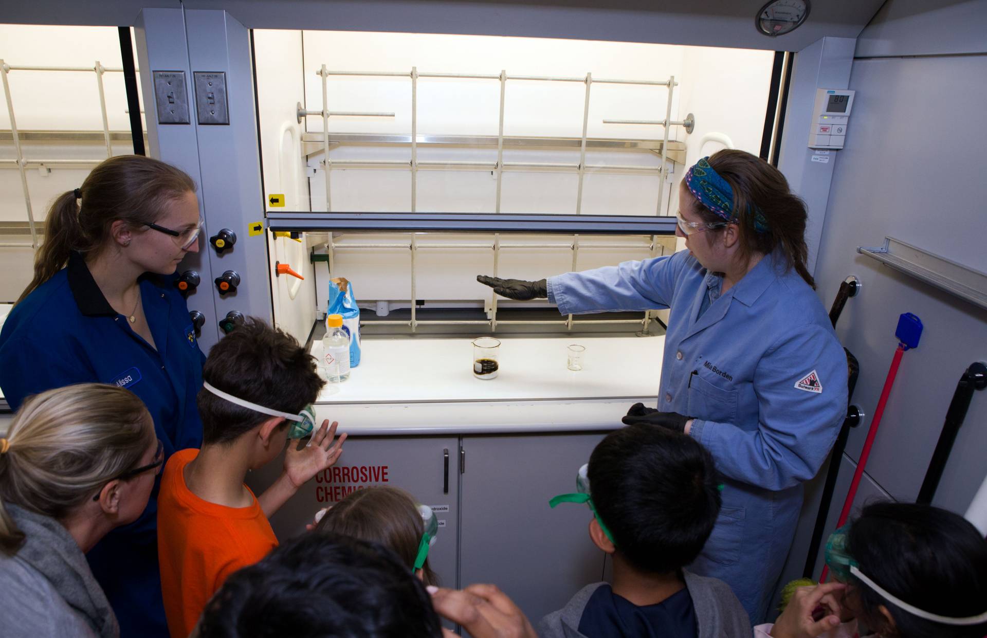 Graduate students show children how to make coal