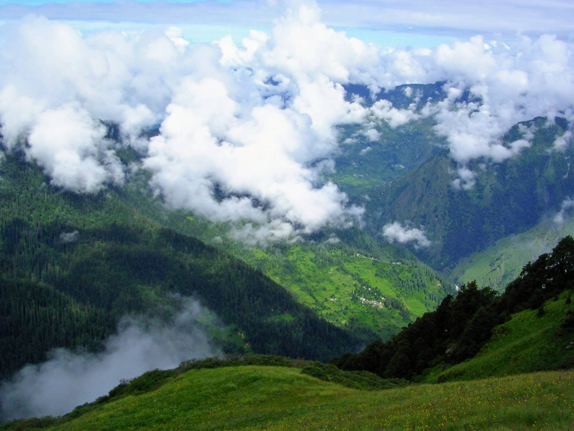 green mountains and fluffy clouds