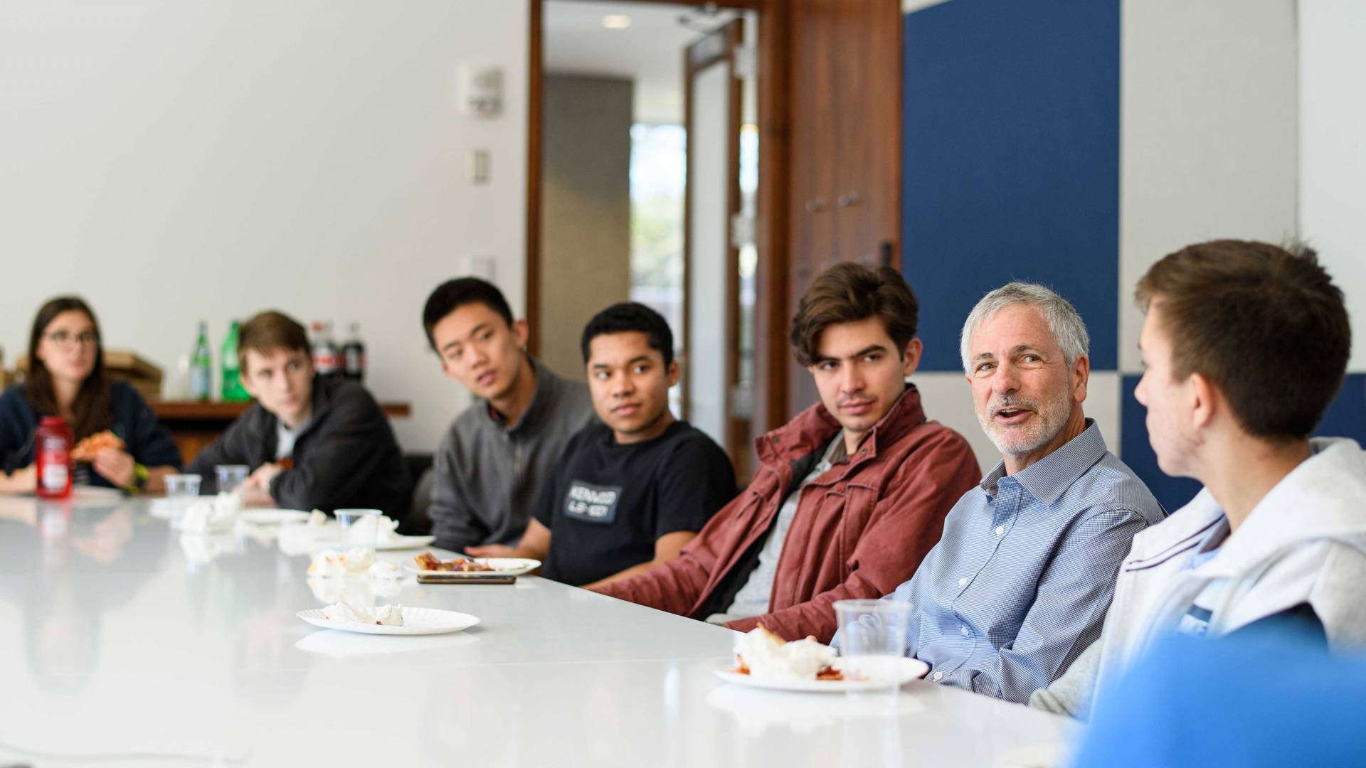 Mike Fox sits at the lunch table with students
