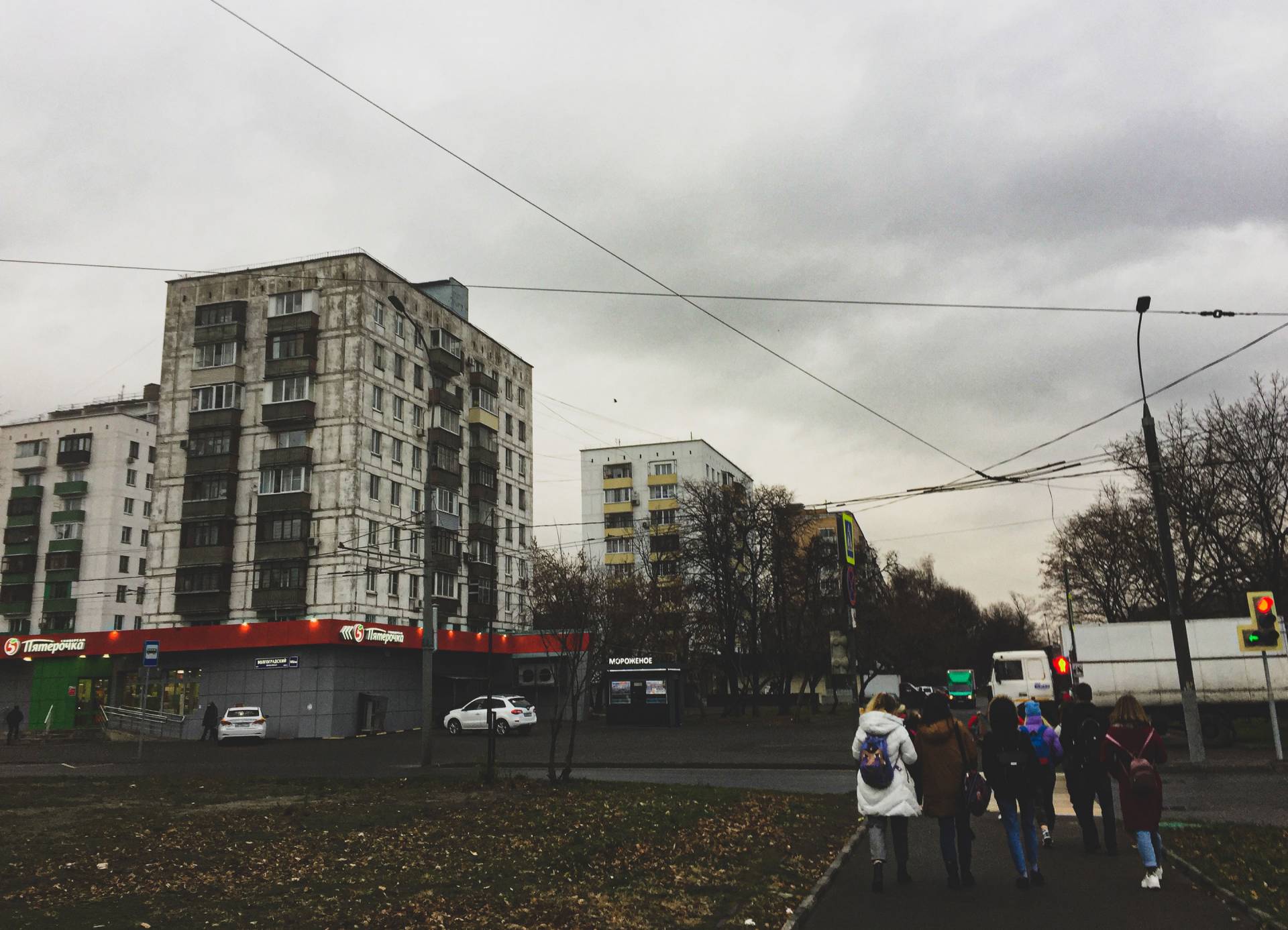 Students walking alongside apartment buildings