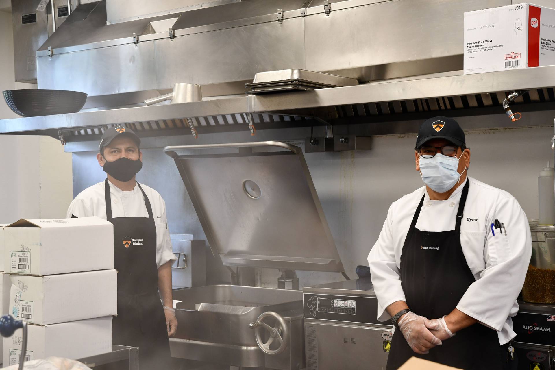 Campus Dining employees work near the grill