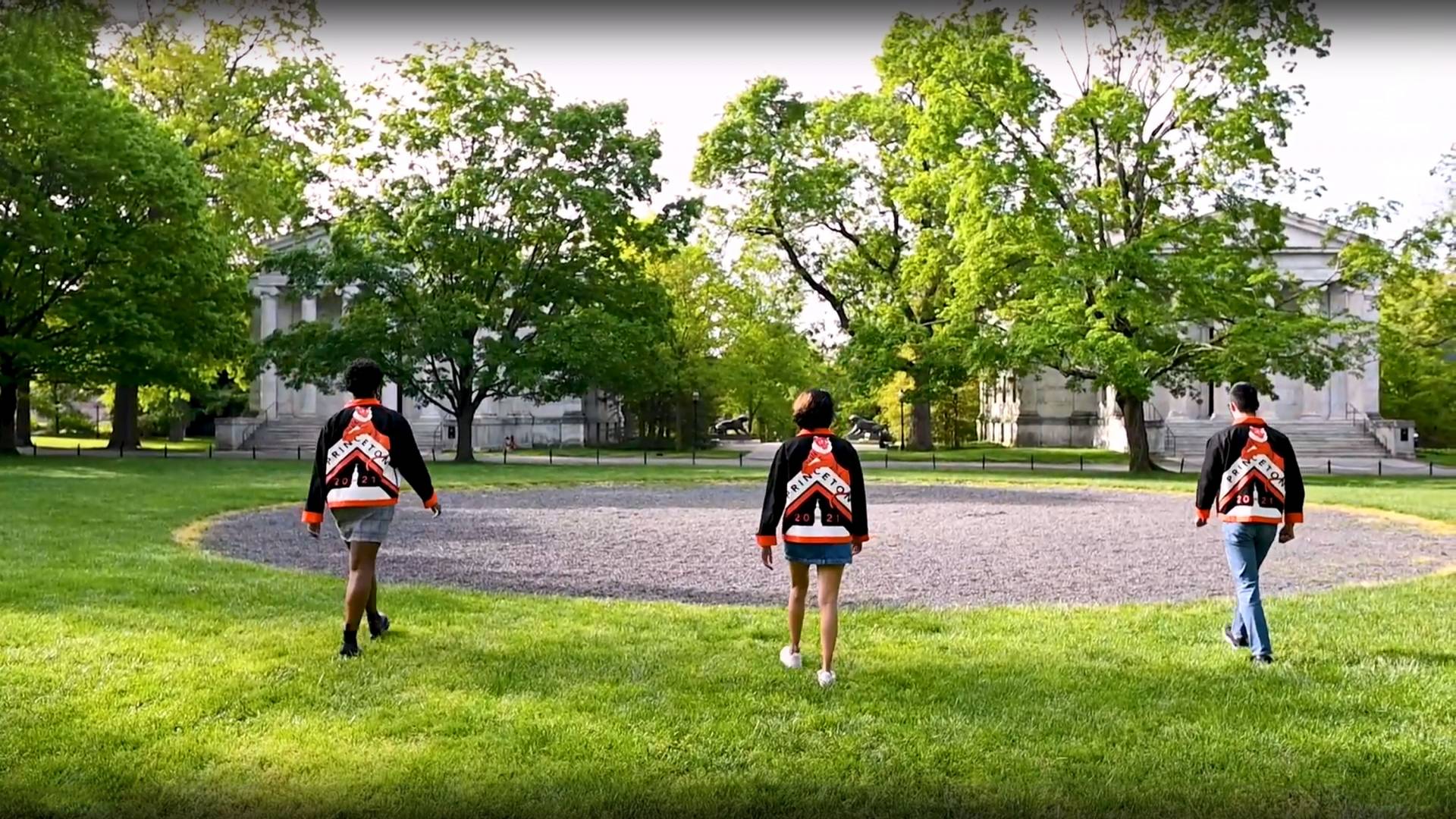 Three students walk toward the cannon