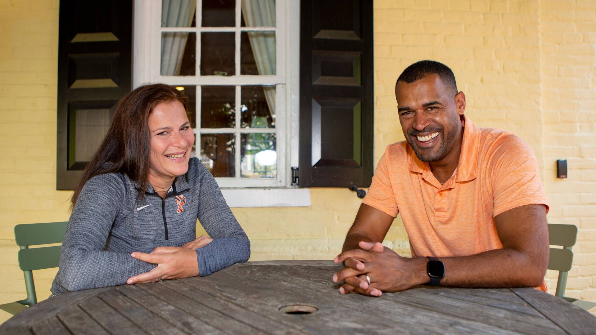 Jess Deutsch and Eric Almonte sit at a table at MacLean House