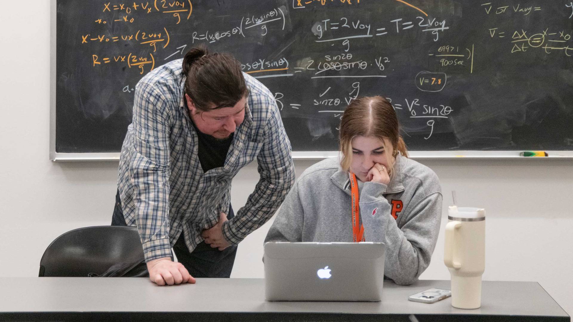 An instructor helps a student