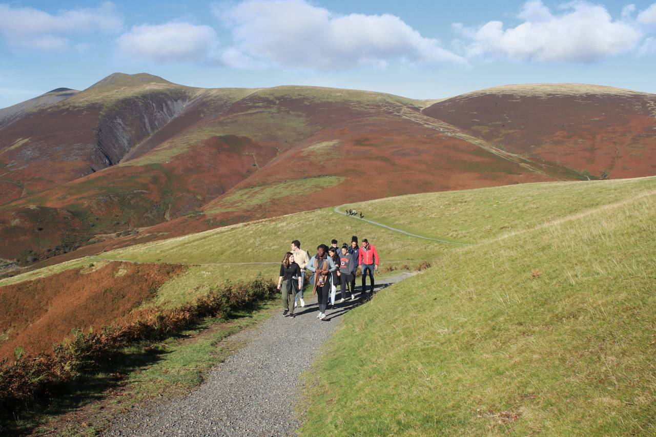 Students walking in between hills
