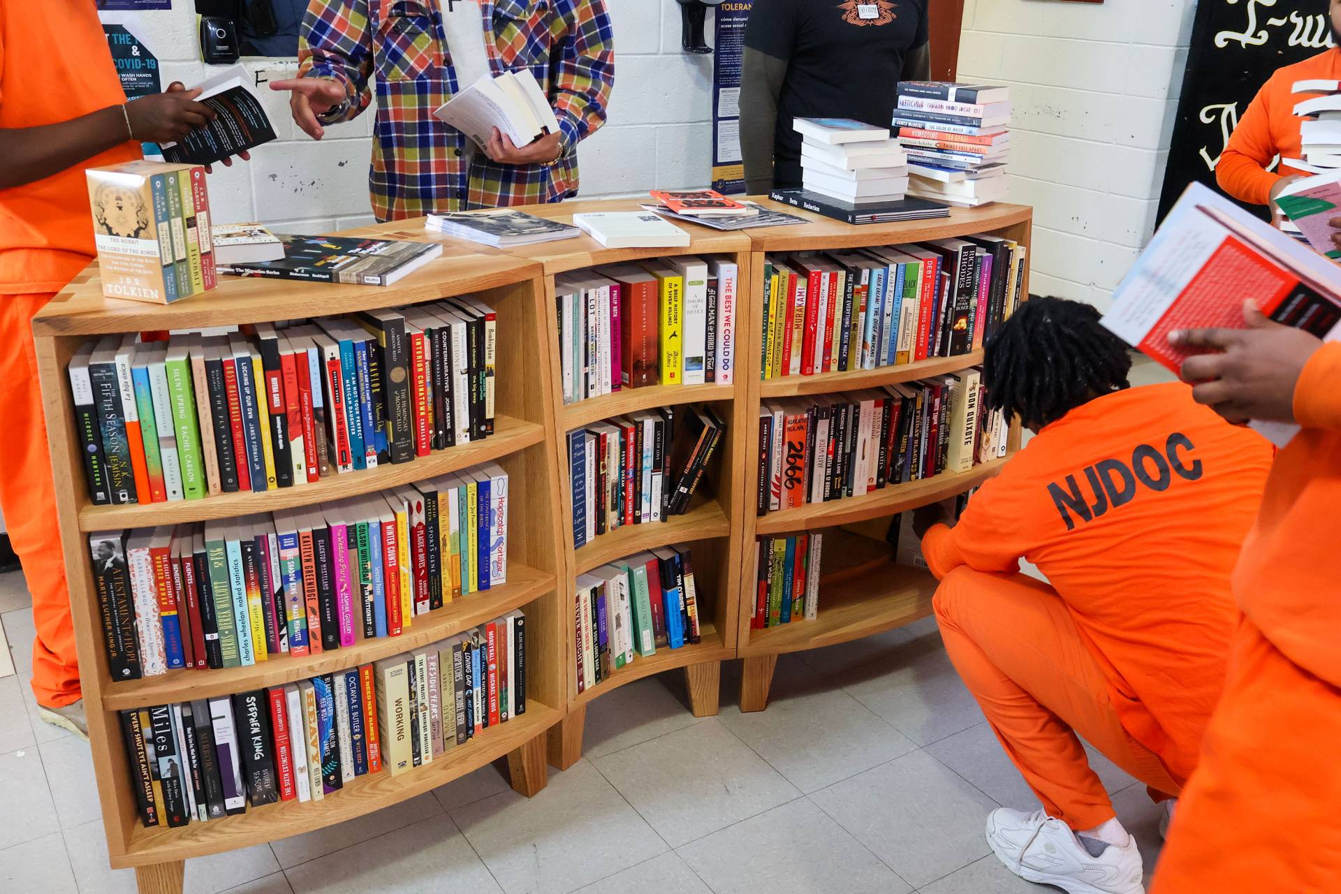 Inmates at the New Jersey Department of Corrections looking at books in the library