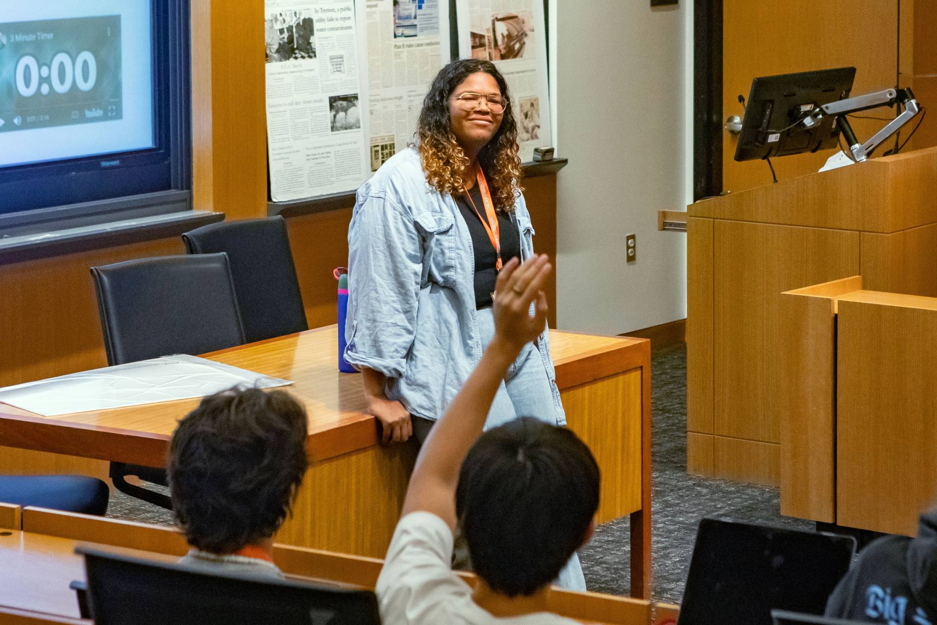 A student raises their hand during a session with a special speaker.