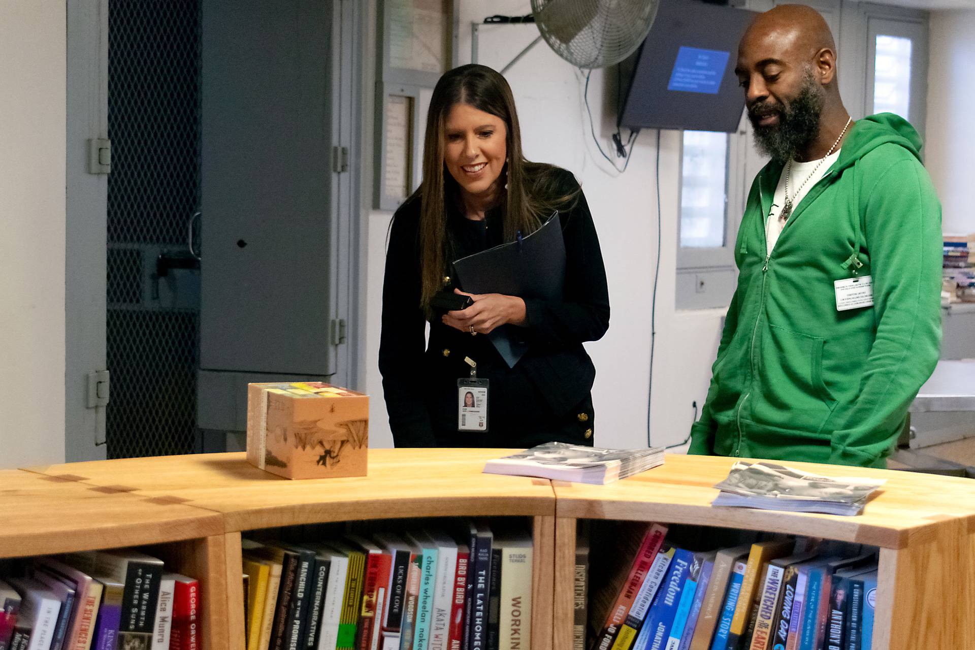 Reginald Dwayne Betts looking at the library with a colleague