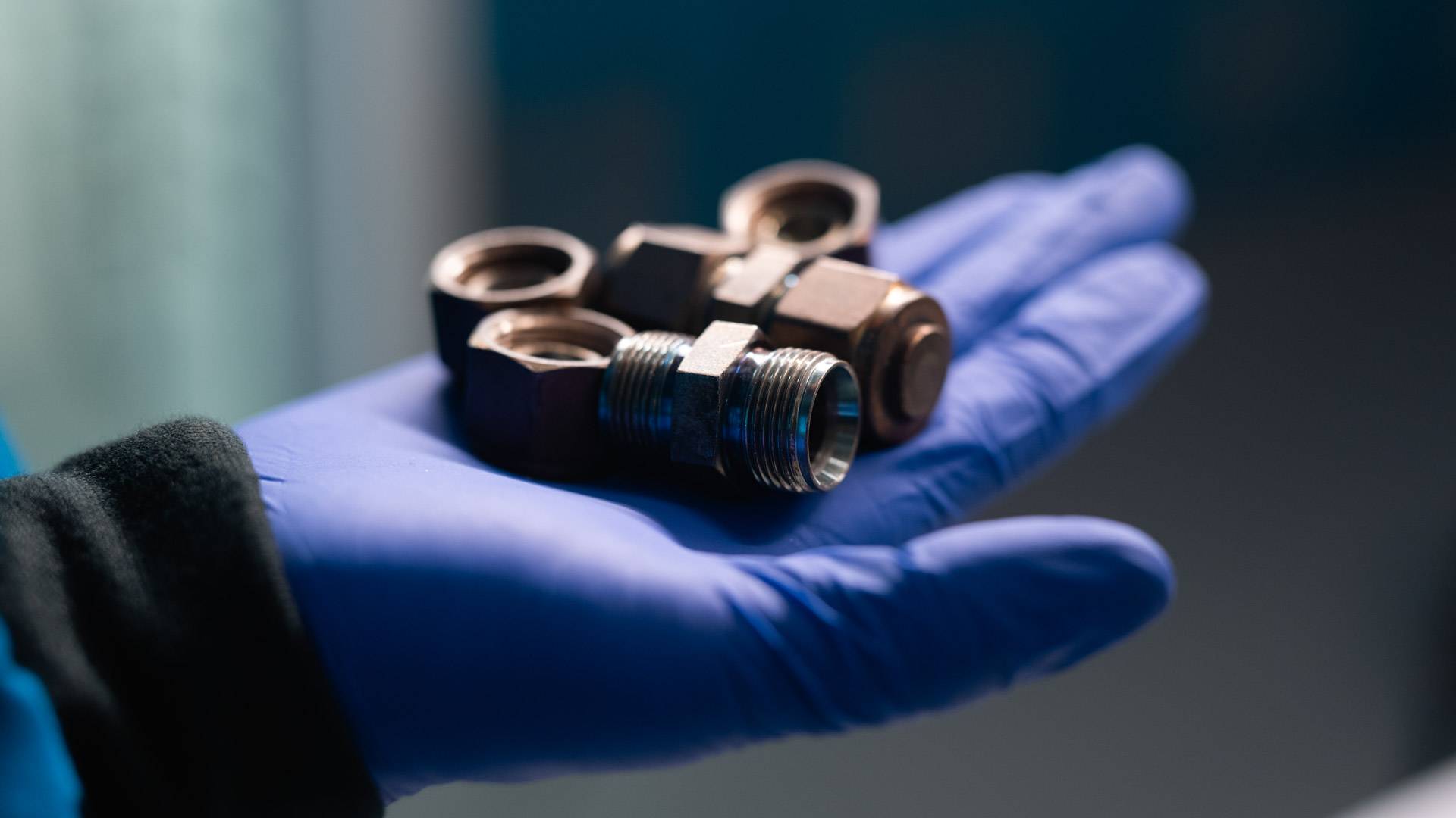 A close-up view of mini chemical reactors made from repurposed stainless steel pipe connectors