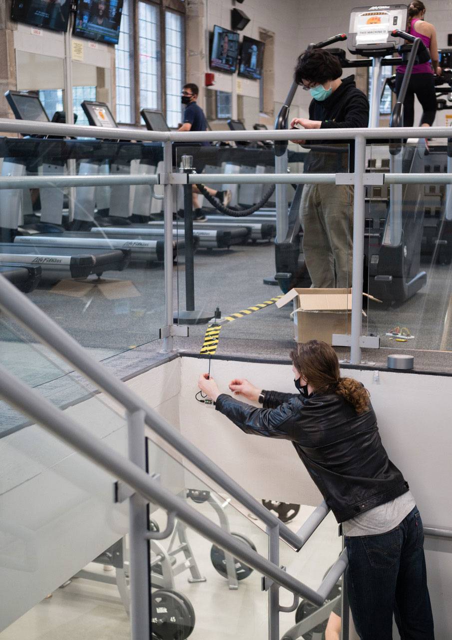 Students install sensors on a wall and collect data