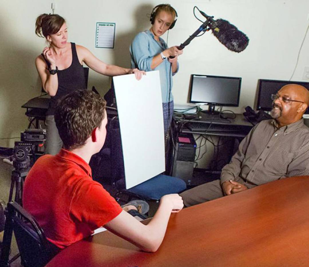 Student team producing a video interview a subject